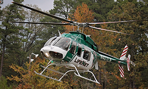 LifeNet Air Medical Helicopter lands with fall leaves in the background.