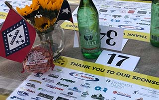 Tablescape for Dine on the Line Texarkana 2018 showing LifeNet EMS as a sponsor.