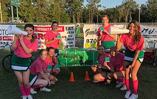 Genoa Central Dragons Friday Night Stroke Zone in Arkansas. Cheerleaders hold BEFAST magnets with signs and symptoms of stroke.