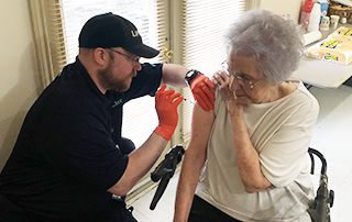 LifeNet Paramedic gives a flu shot in Stillwater