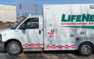 LifeNet ambulance drives in the 2018 Toys for Tots Parade in Texarkana near Central Mall.