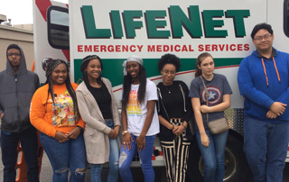 Arkansas High School students stand in front of a LifeNet ambulance.