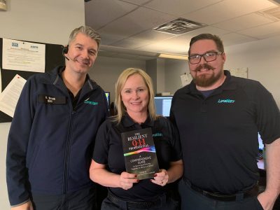 LifeNet EMS dispatchers hold a copy of the Resilient 9-1-1 Professional book.