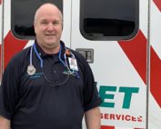 LIfeNet Paramedic Bob Flotkoetter standing in front of a LifeNet Ambulance.